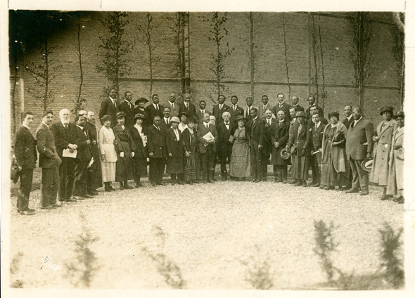 Two rows of men and women in formal dress standing outside